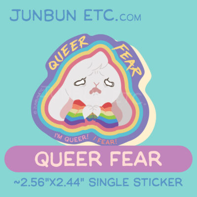 A graphic showing the Queer Fear single sticker design depicting JunBun - the white bunny mascot - in deep fear, their face looking crumpled and terrified as they clutch a rainbow flag around them. Above their head is the text "Queer Fear," and the caption below says "I'm queer! I fear!"