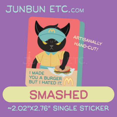 A graphic showing the Smashed single sticker design depicting MaxCat - the black cat mascot - as a uniformed MewBunny's fast food worker, staring angrily at the viewer, a fist smashing a burger into the counter in front of him. The caption next to the MewBunny's logo says "I made you a burger but I hated it," in the vein of a classic derivative lolcat meme, "I made you a cookie but I eated it."